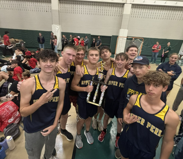 Boys XC celebrating their win, pulled from @upboysxc on Instagram