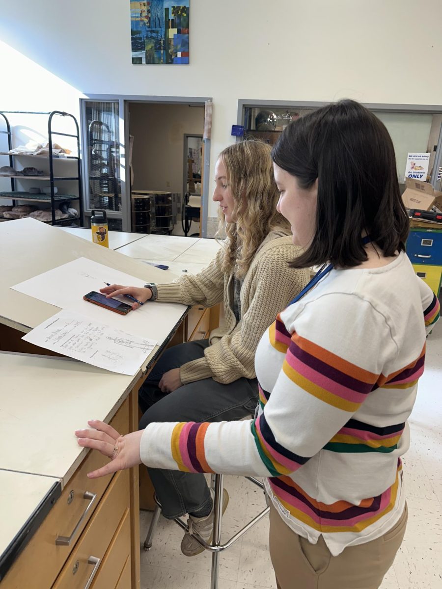 Mrs. Smith helping Barron Strouse with her drawing 