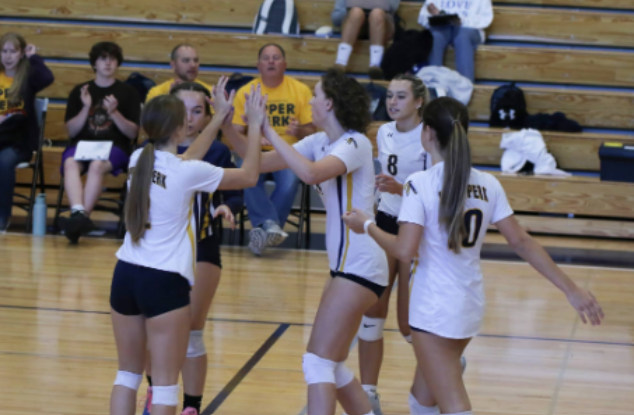 The girls' varsity team celebrating a successful point, pulled from Christmas City Studios. 