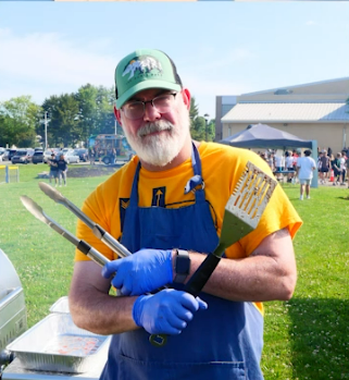 Mr. Austin posing as he grills at last year's Great Outdoors Day